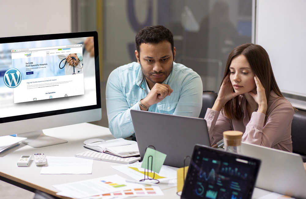 Image of a man and women using managed wordpress hosting on their computer